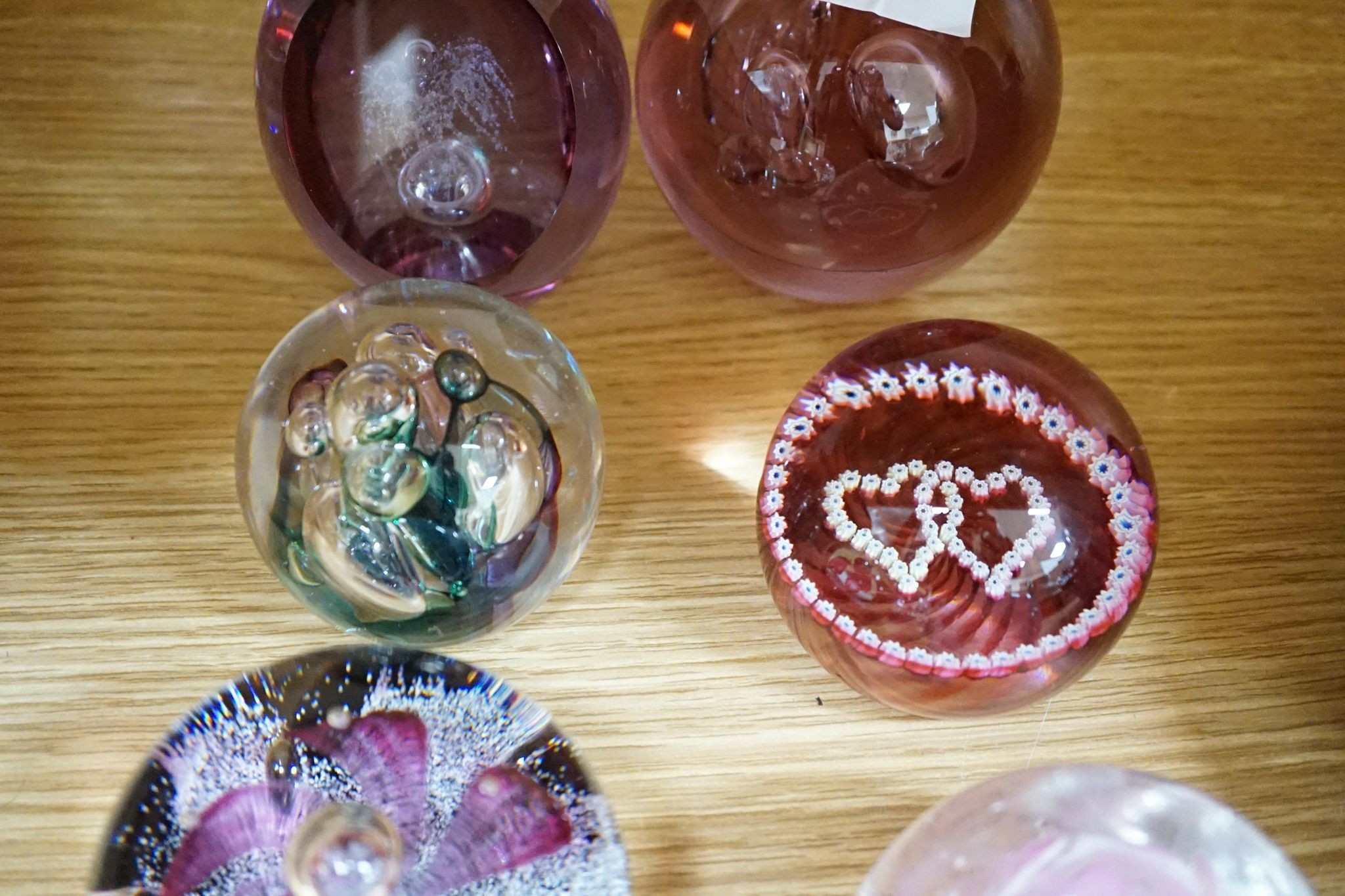 A group of glass paperweights including Caithness